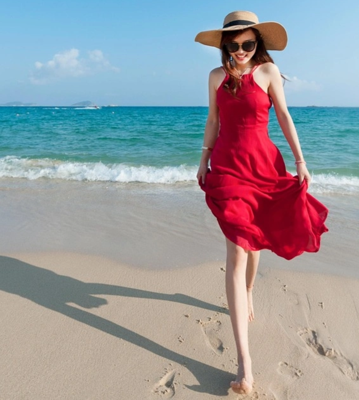 a womanin red dress on the beach